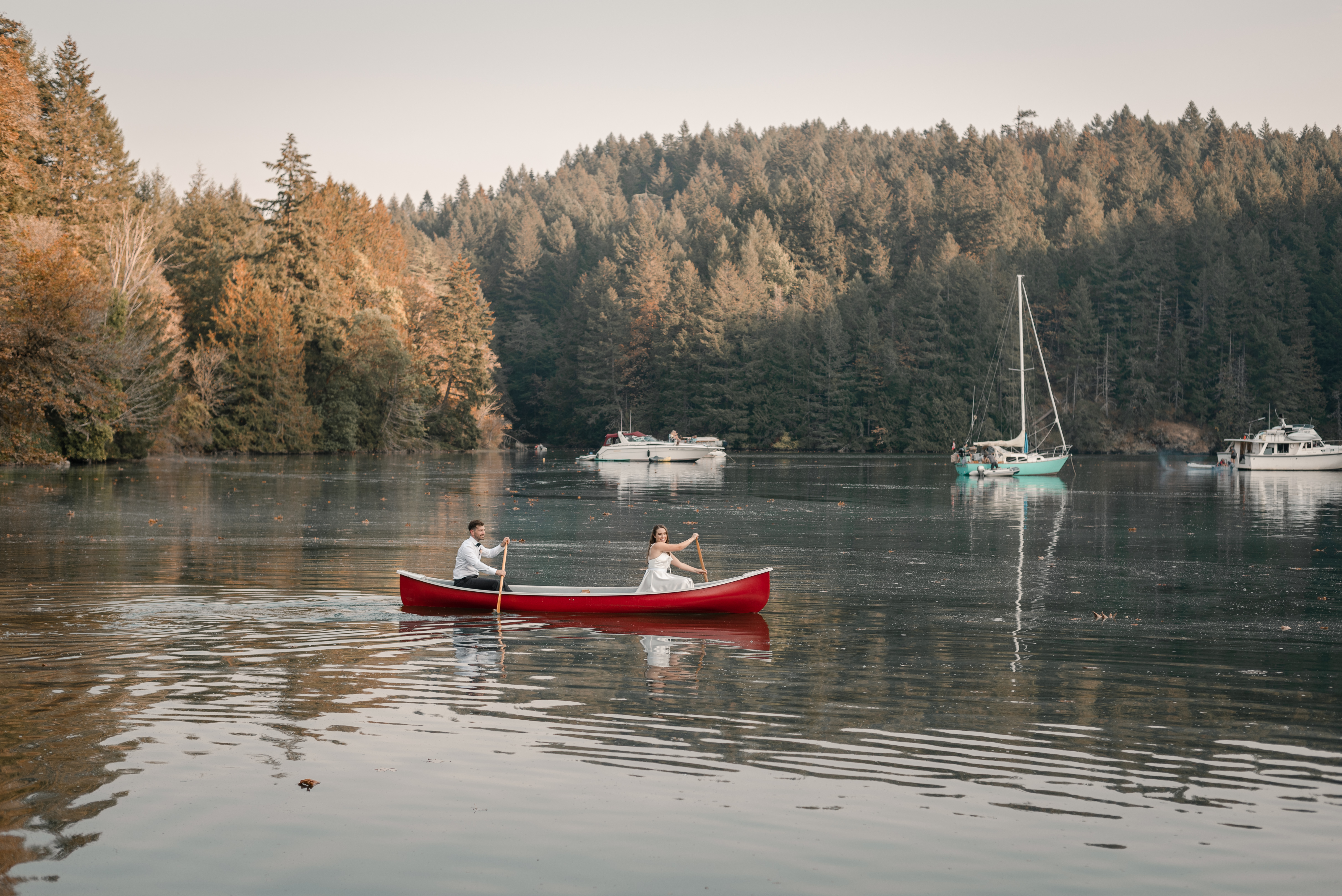 Couple canoeing together during an intimate micro wedding at Tod Inlet, Vancouver Island, BC.