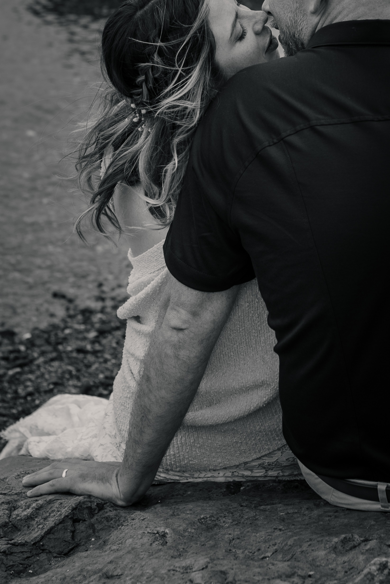 A couple on their wedding day kissing down at the ocean in Victoria BC.