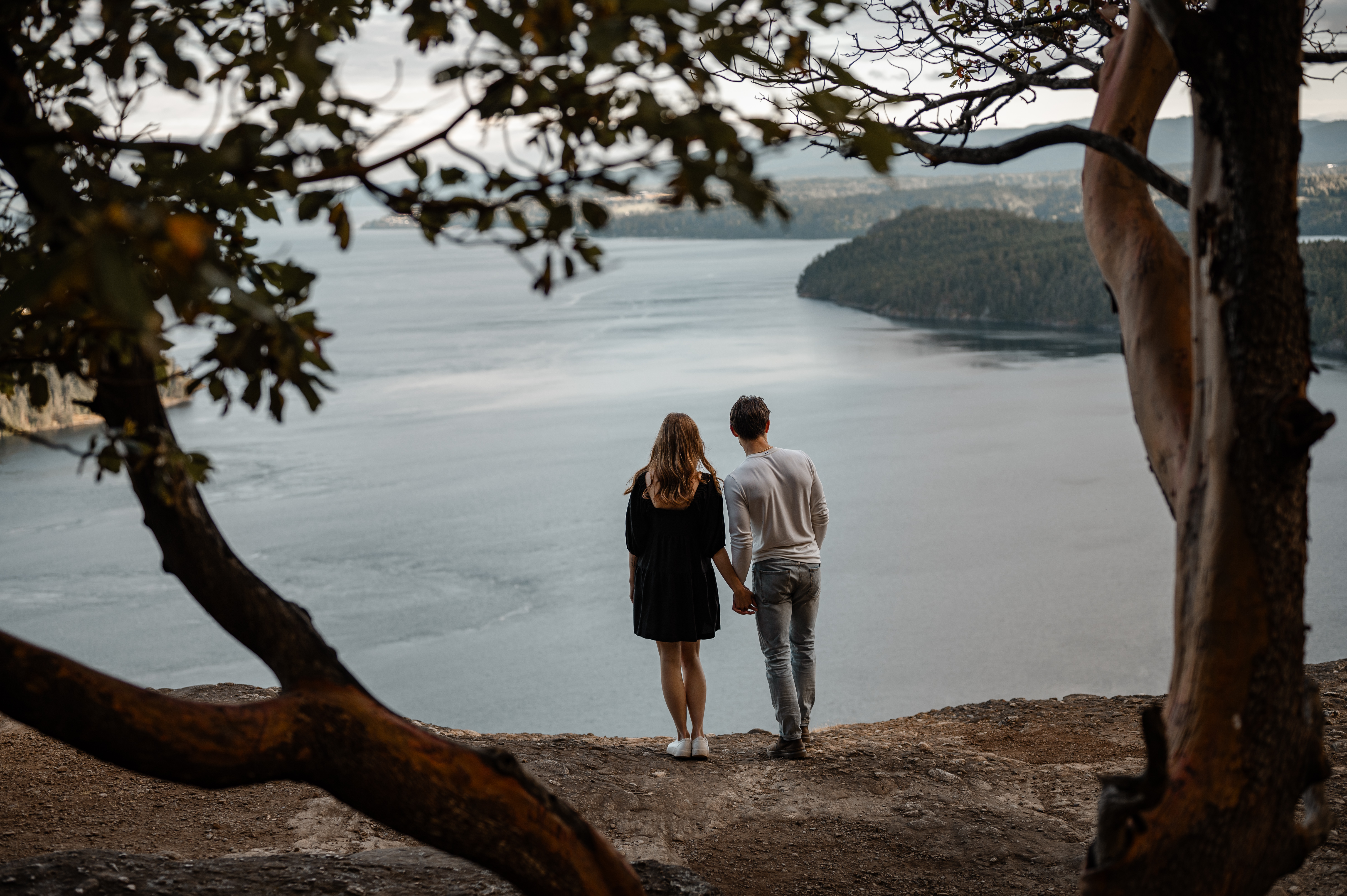 Couple stands looking at the scenic view at Stoney Hill Regional Park on Vancouver Island