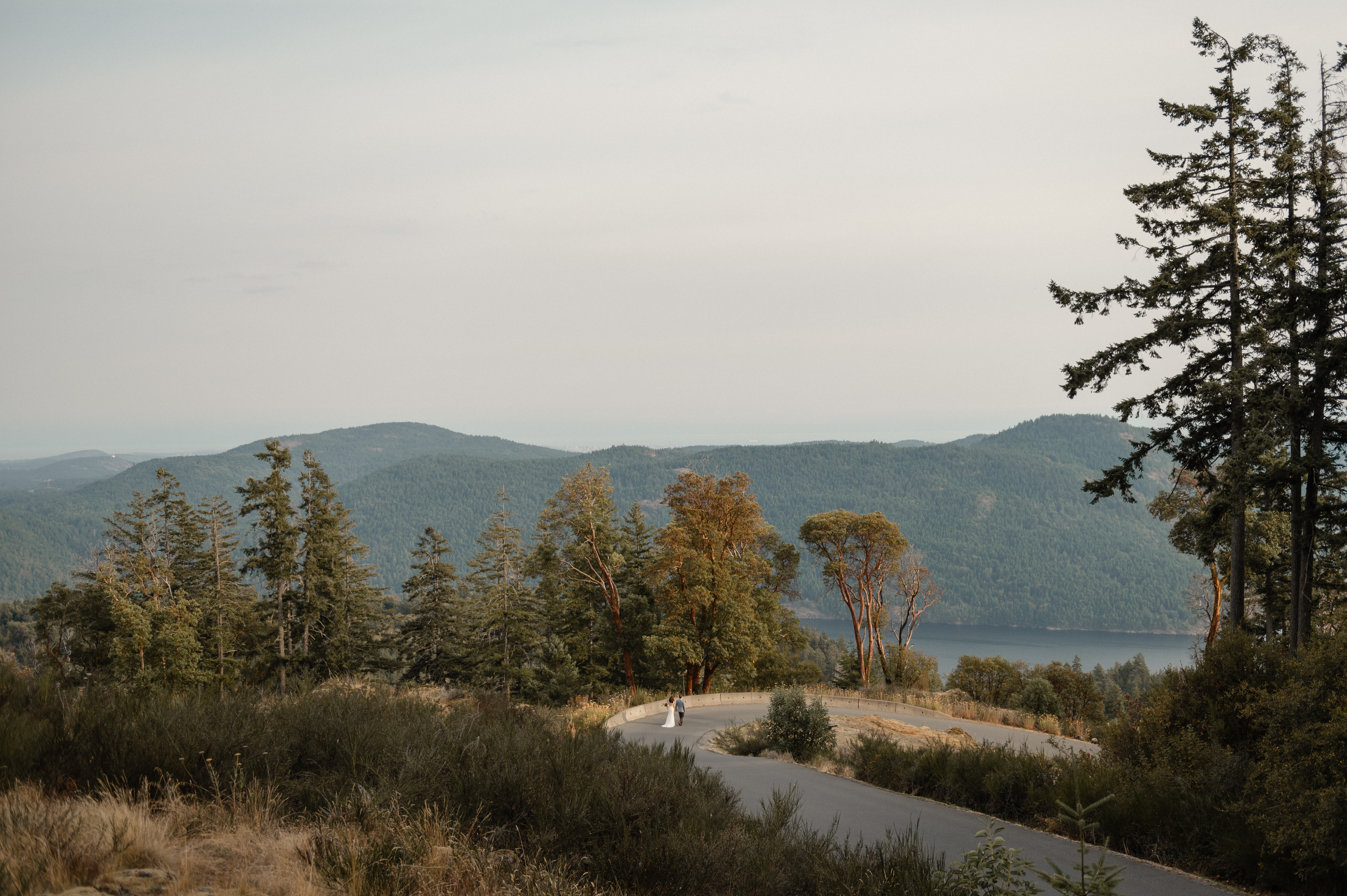 Couple walking the scenic driveway at Villa Eyrie Resort overlooking the Saanich Inlet.