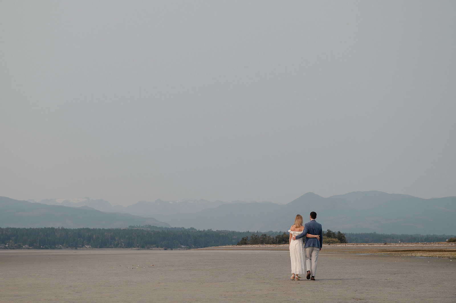 Couple walking along Goose Spit during a relaxed Comox Valley engagement session